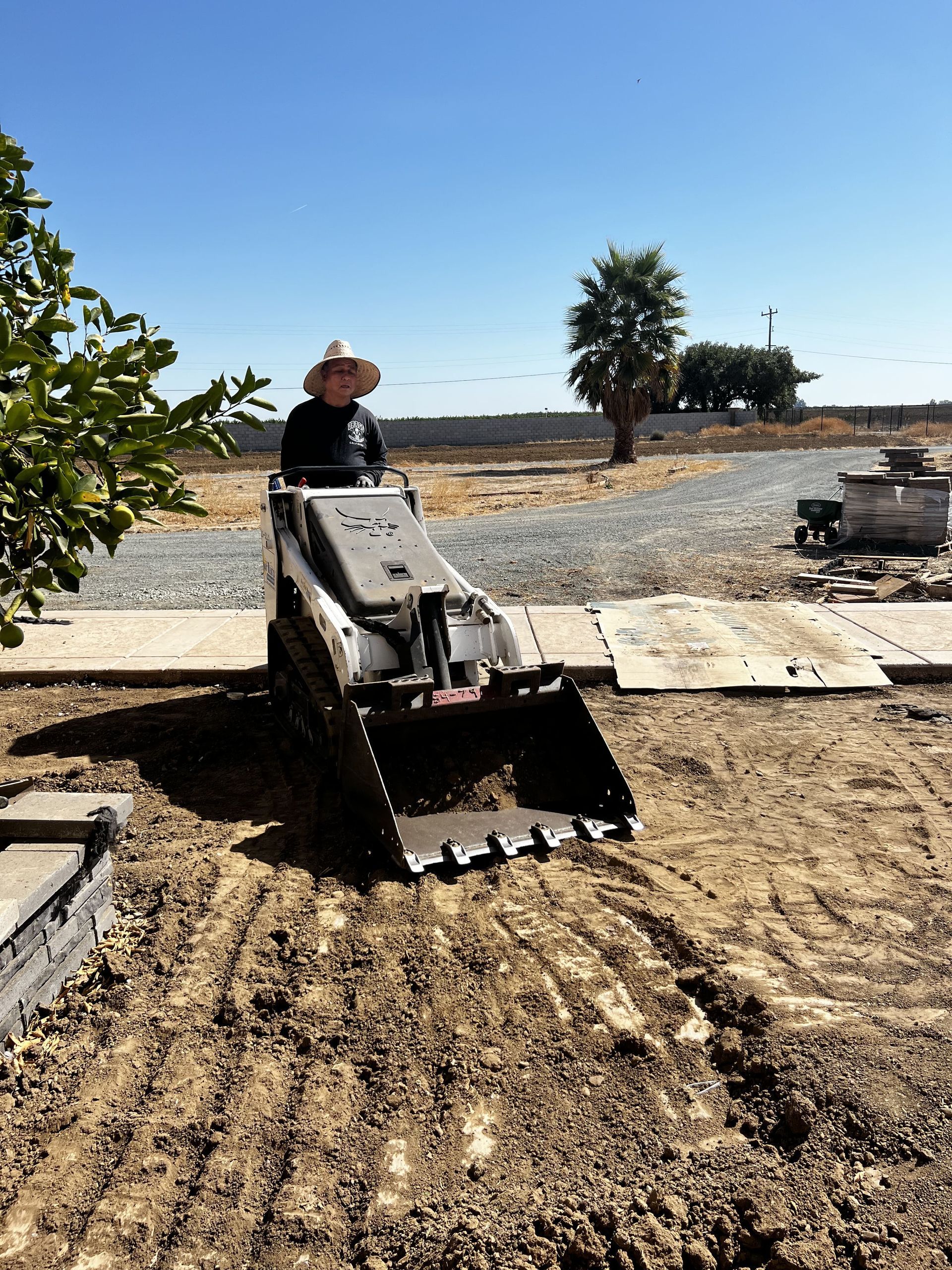 Landscaper preparing soil base for turf installation in Stockton.