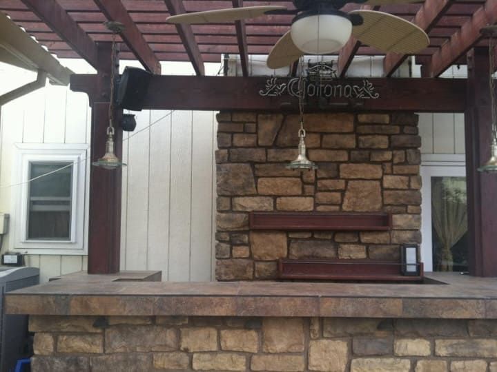 Outdoor kitchen construction in landscaped backyard Stockton.
