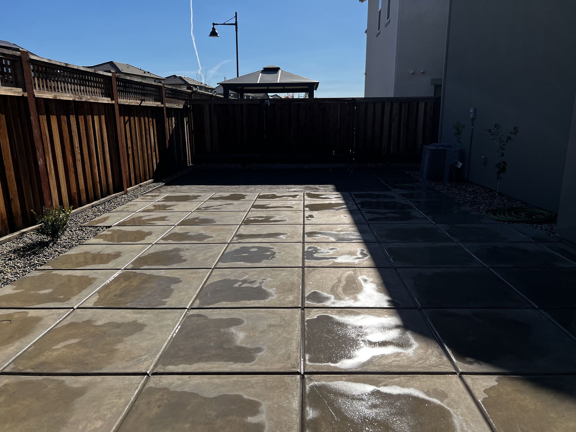 Concrete patio curing process at a Stockton home showing smooth surface and proper hydration