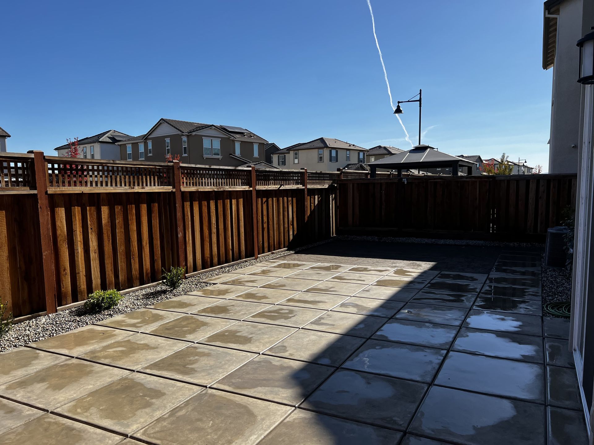 Freshly poured concrete driveway curing in a Stockton residential project with protective finish applied