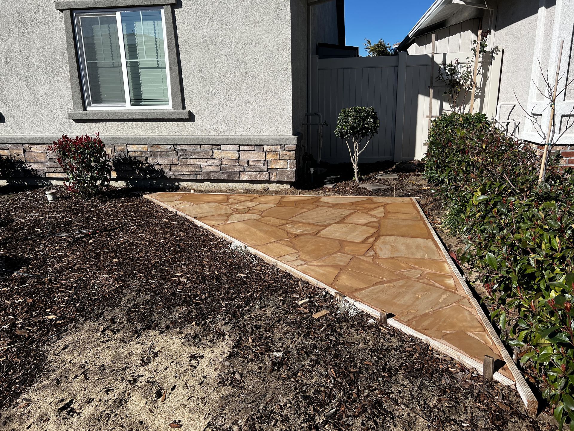 Decorative stamped concrete patio installation for outdoor living space in Stockton California