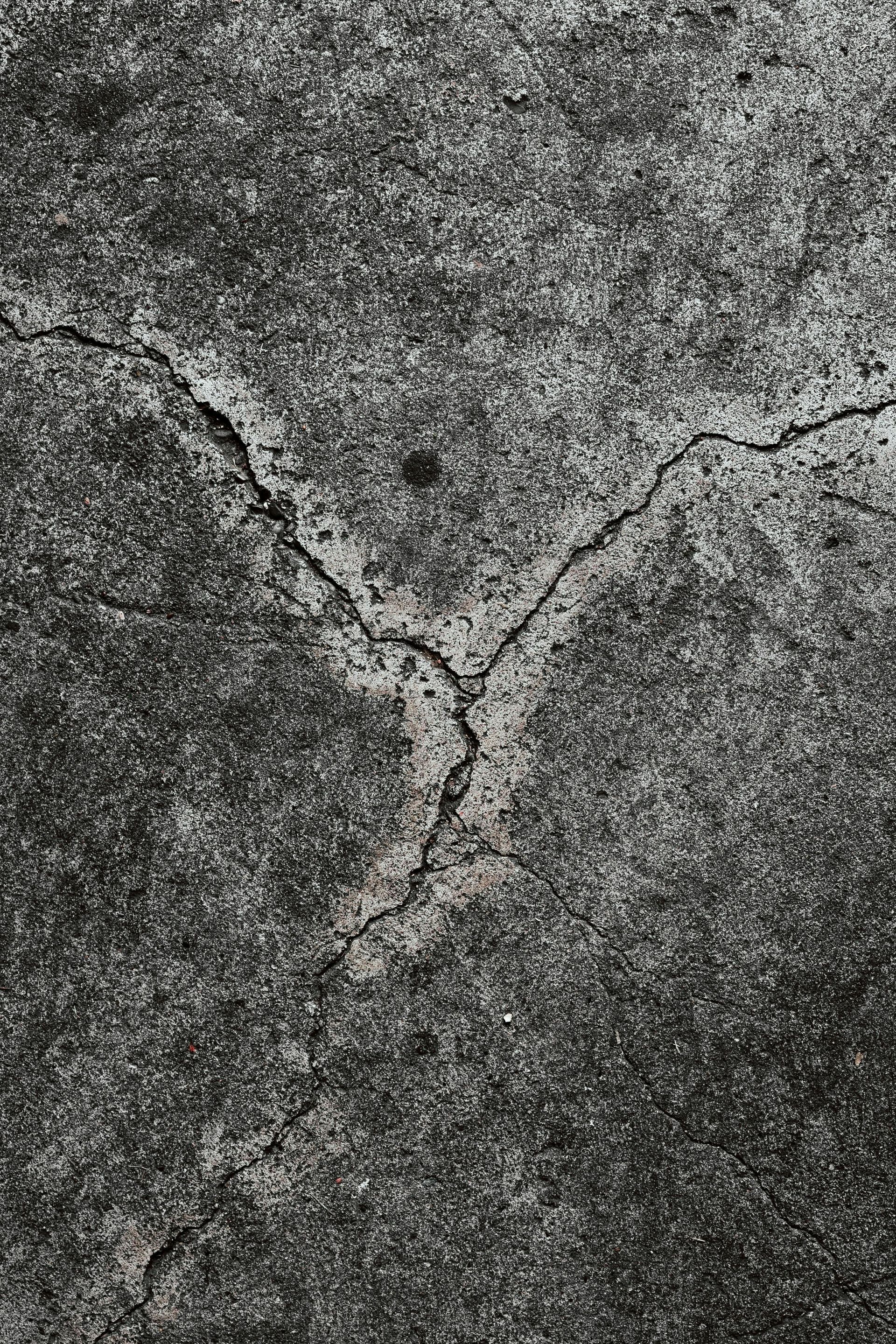 Close-up of cracked concrete driveway showing surface damage on a residential property in Stockton