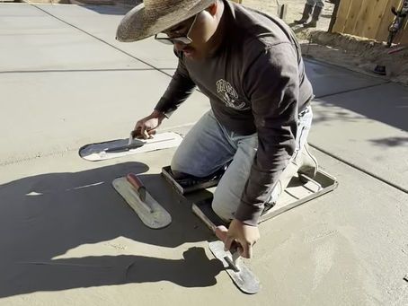 Stockton landscaping contractor leveling concrete with precision tools.