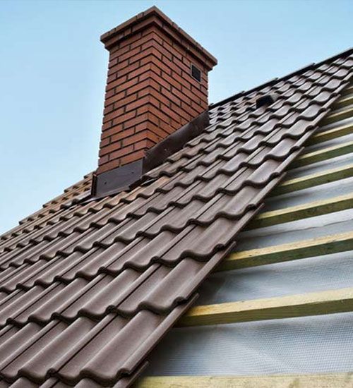 a roof with a chimney on top of it is being built .