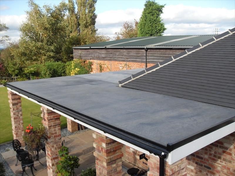 The roof of a house with a black roof