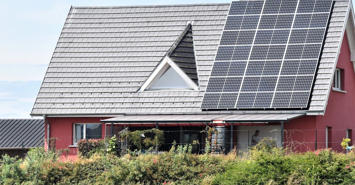 A red house with solar panels on the roof