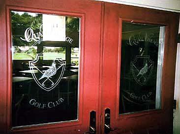 Red doors with etched logo of Quail Ridge Golf Club.
