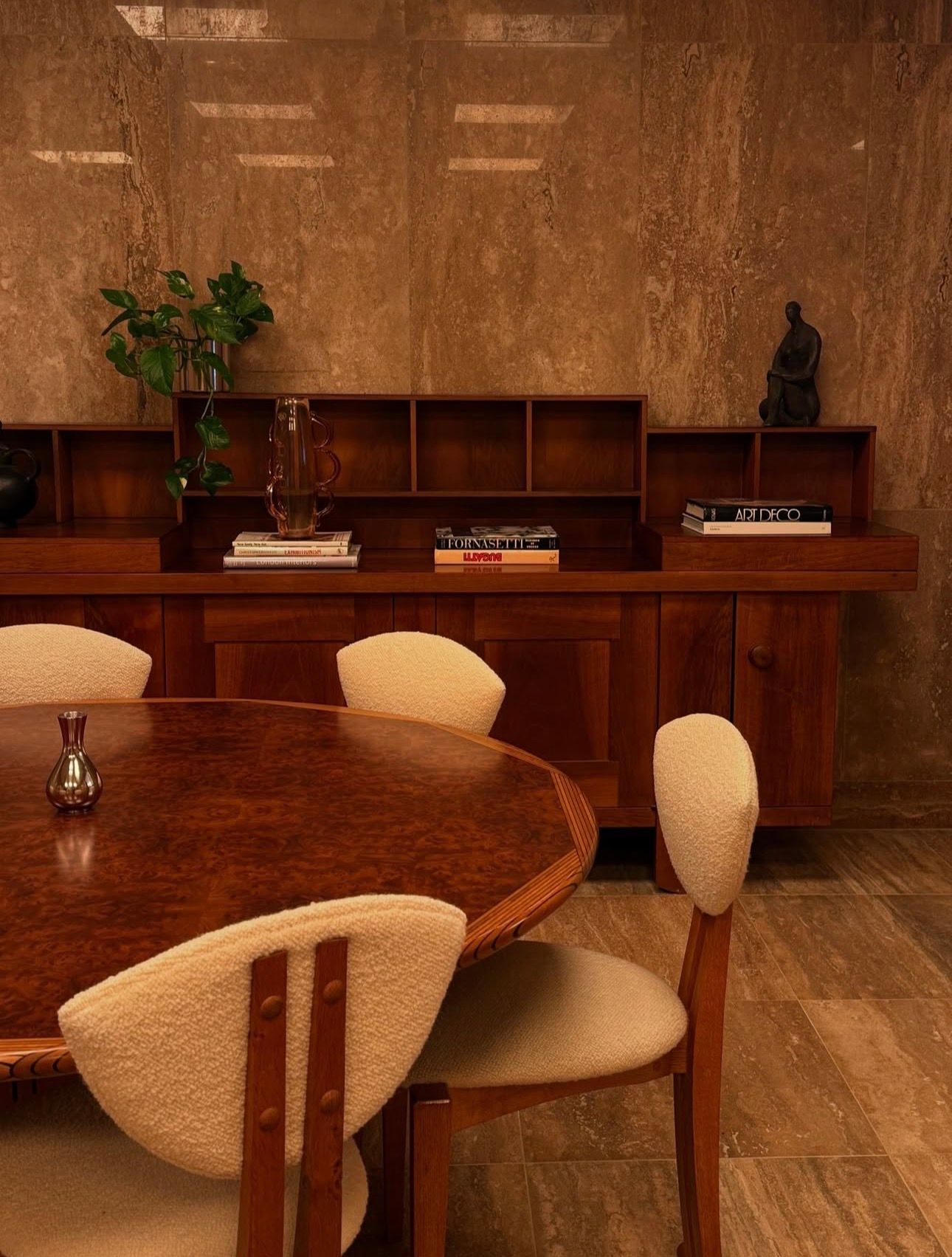 WSA with large window overlooking a cityscape. Yellow armchair, potted plant, and flowers in view.