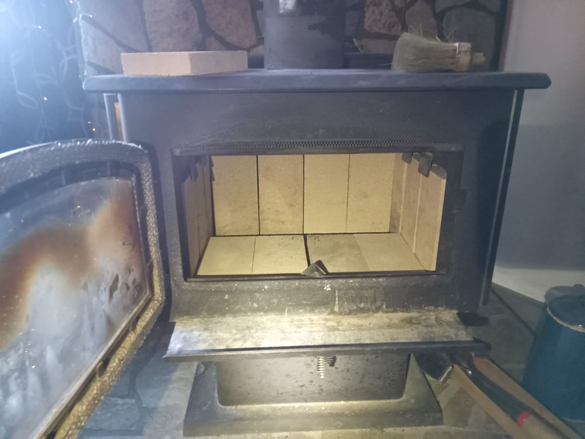 The inside of a wood stove with the door open