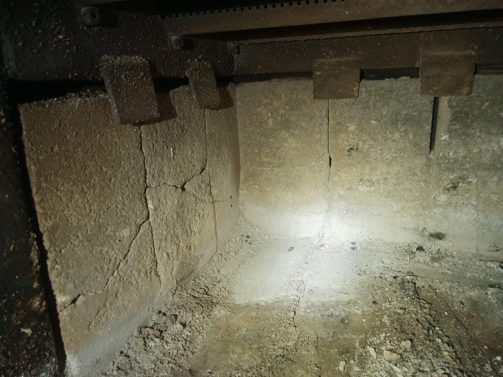 A close up of a dirty room with a light shining on it.