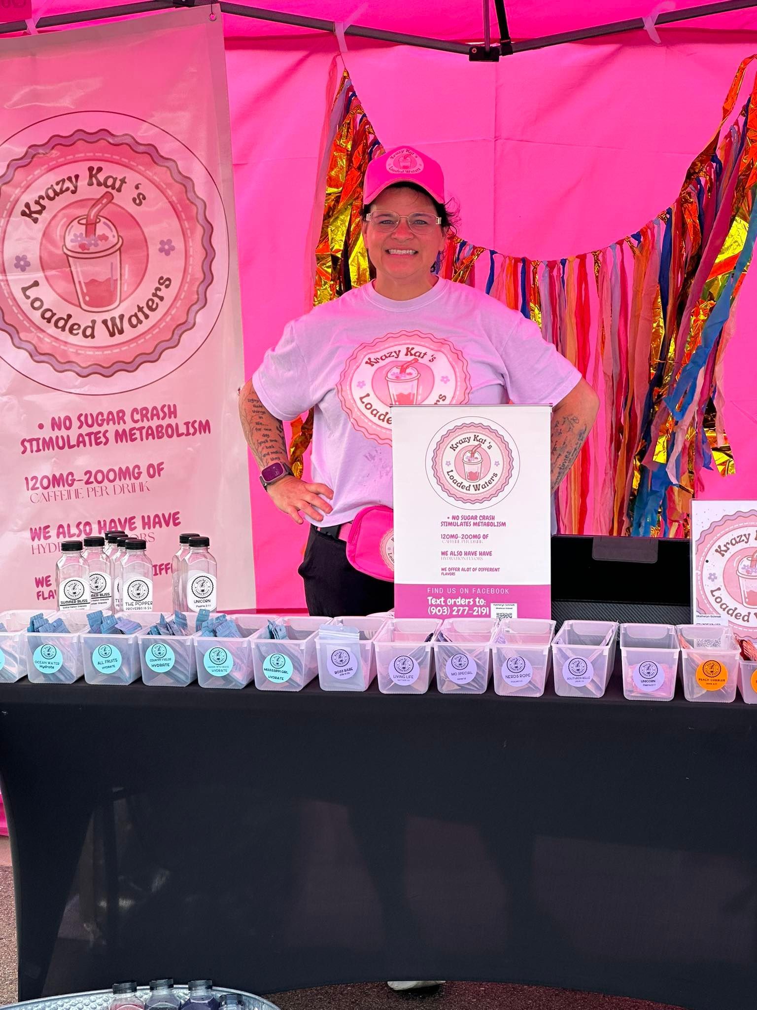 Woman at a pink booth selling