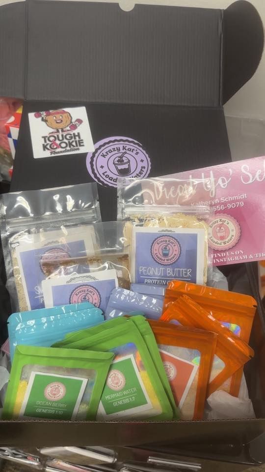 Box of packaged cookies and treats, with stickers and a pamphlet.