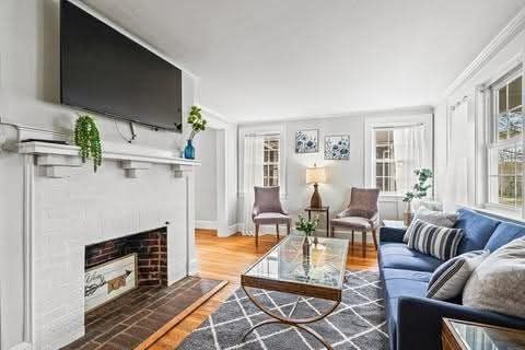 Bright Melrose MA living room with plastered ceiling, refinished hardwood floors, and fresh paint