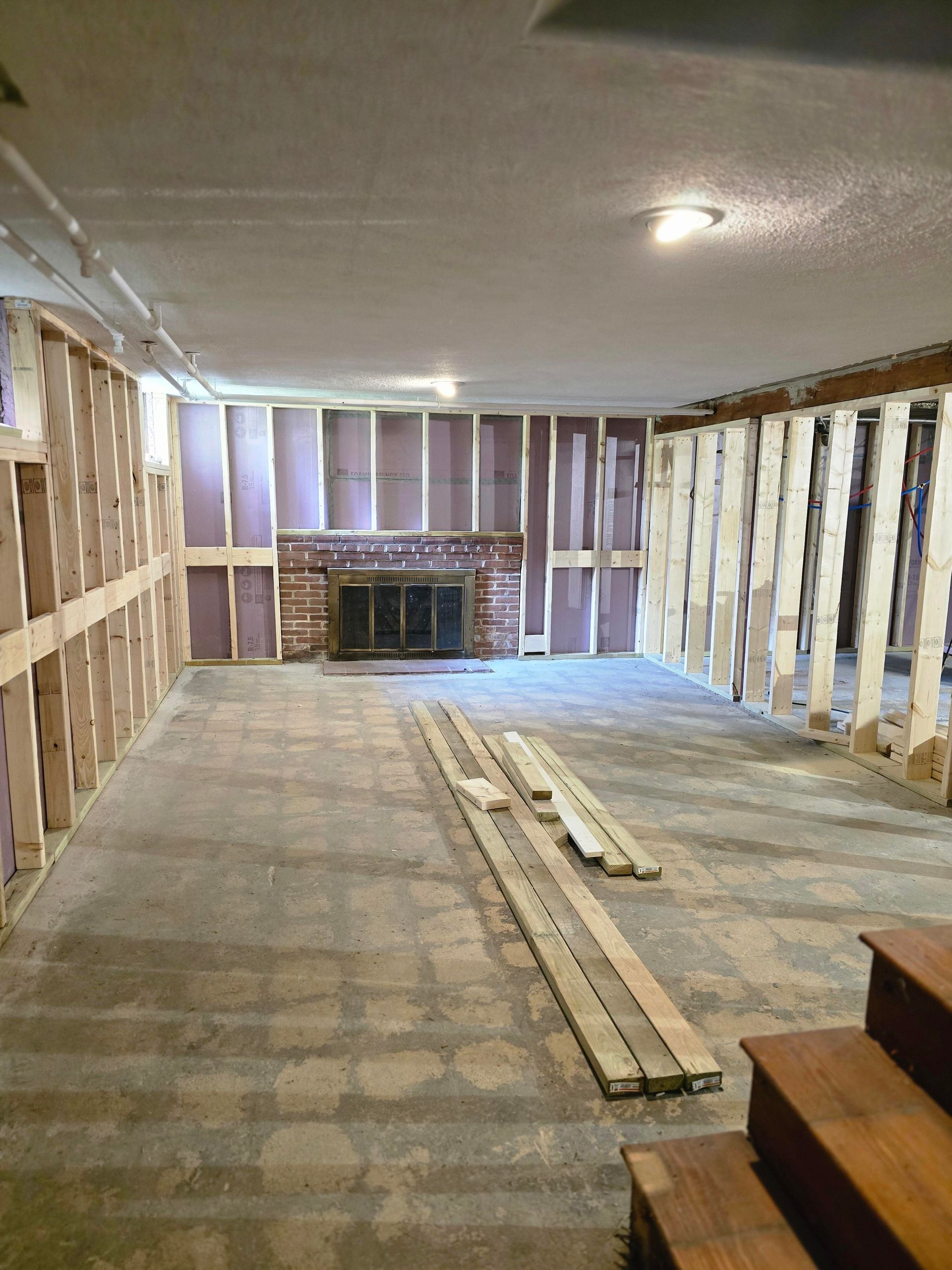 Unfinished basement framing and insulation during a Melrose MA remodeling project.