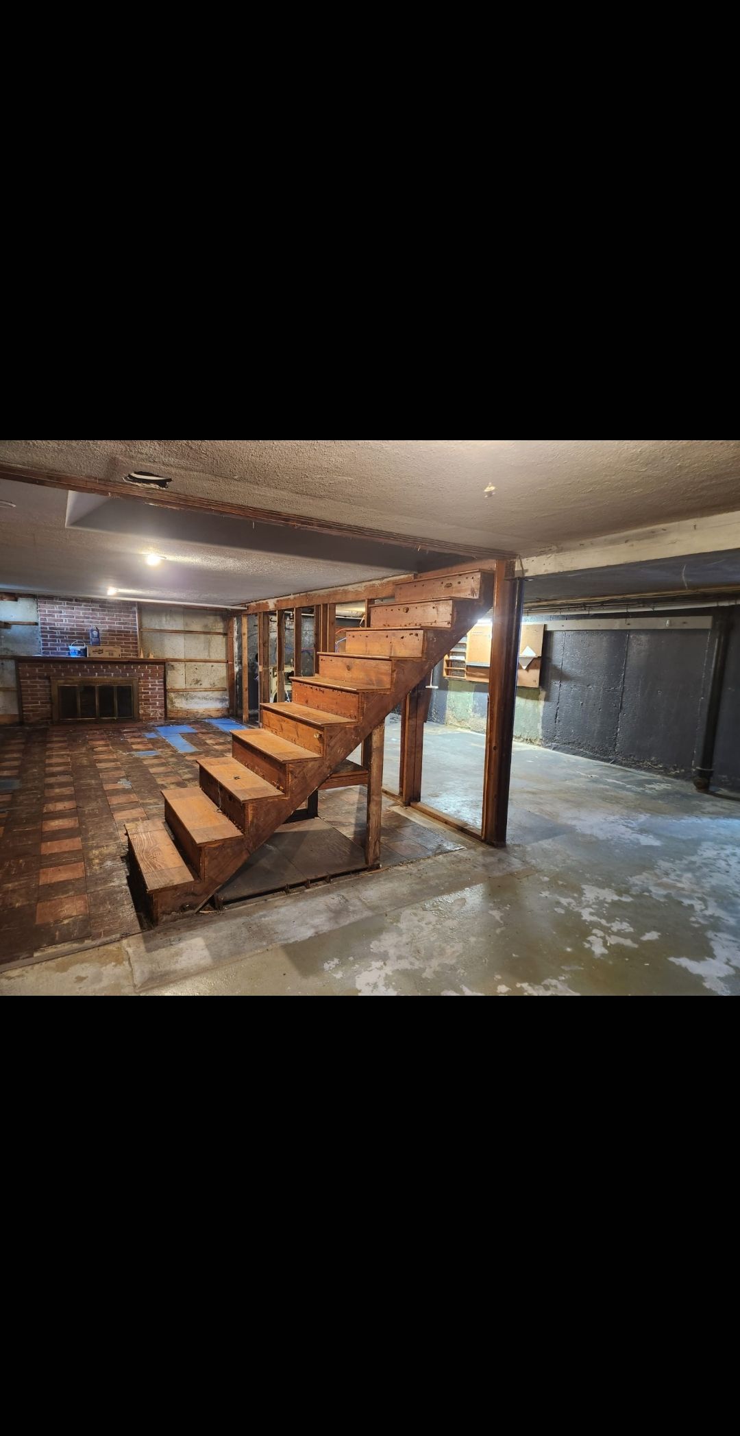 Unfinished basement framing and insulation during a Melrose MA remodeling project.