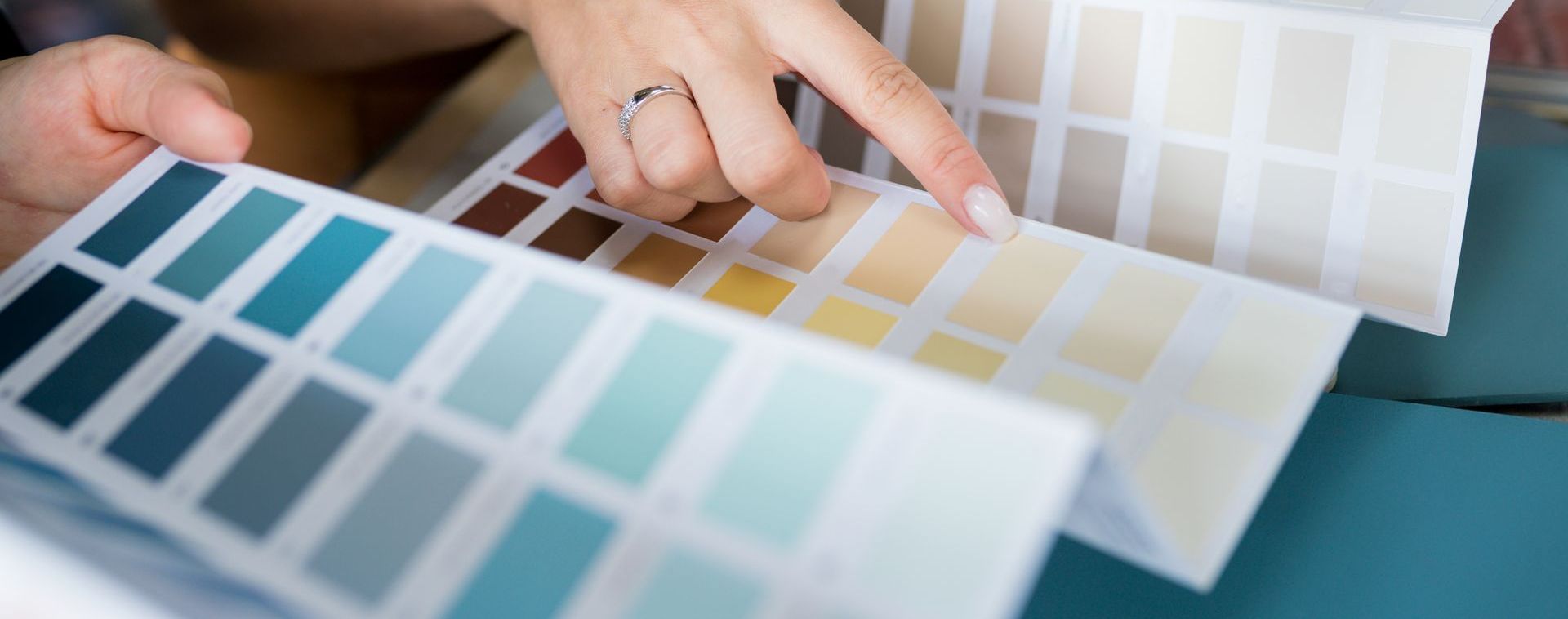 Person reviewing the Top Interior Paint Color Trends for 2025