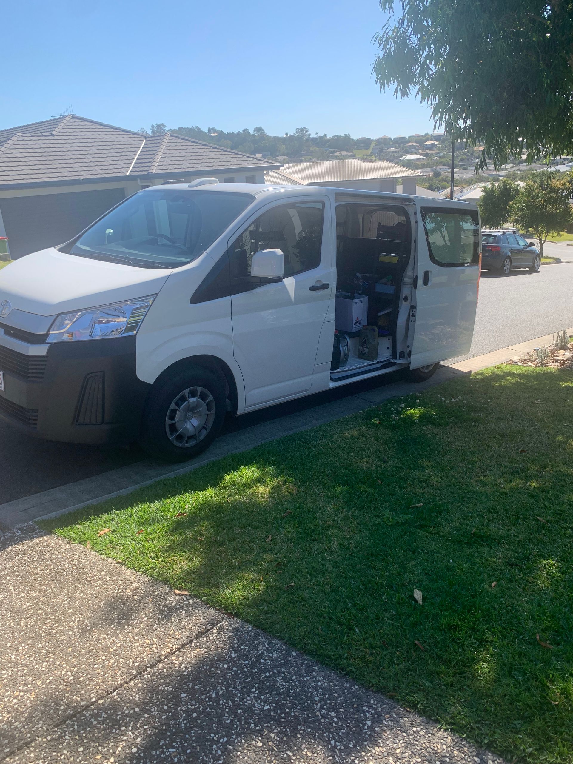 White Van Parked on a Residential Street With Open Side Doors — Calvin's Mobile Mechanics In Elanora, QLD