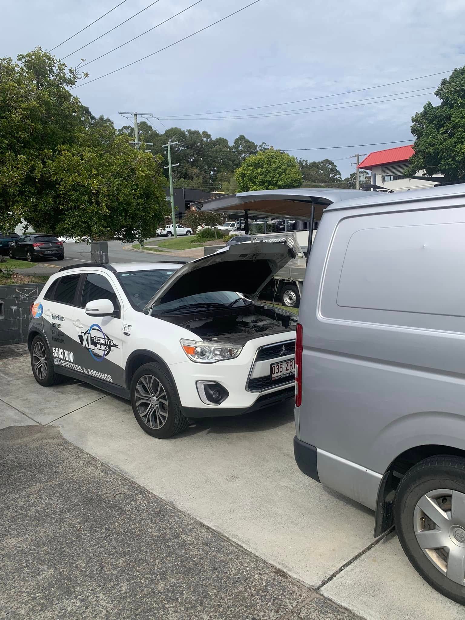 White SUV with Open Hood Next to Grey Van — Calvin's Mobile Mechanics In Elanora, QLD