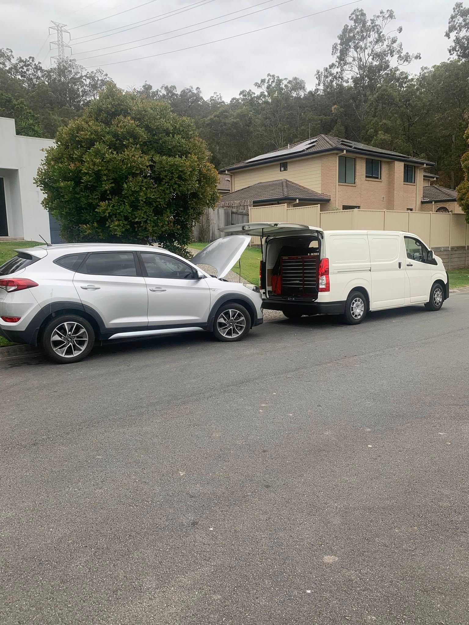 Silver SUV and White Van Parked on a Street With Open Hoods — Calvin's Mobile Mechanics In Elanora, QLD