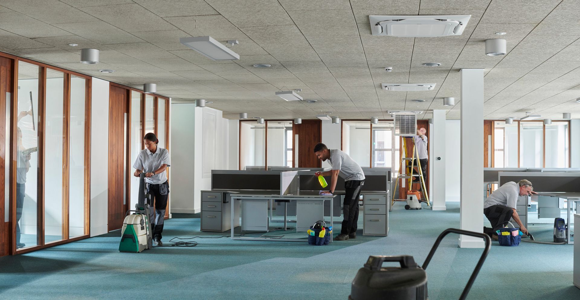 Happy cleaning team providing professional commercial cleaning with a friendly attitude.