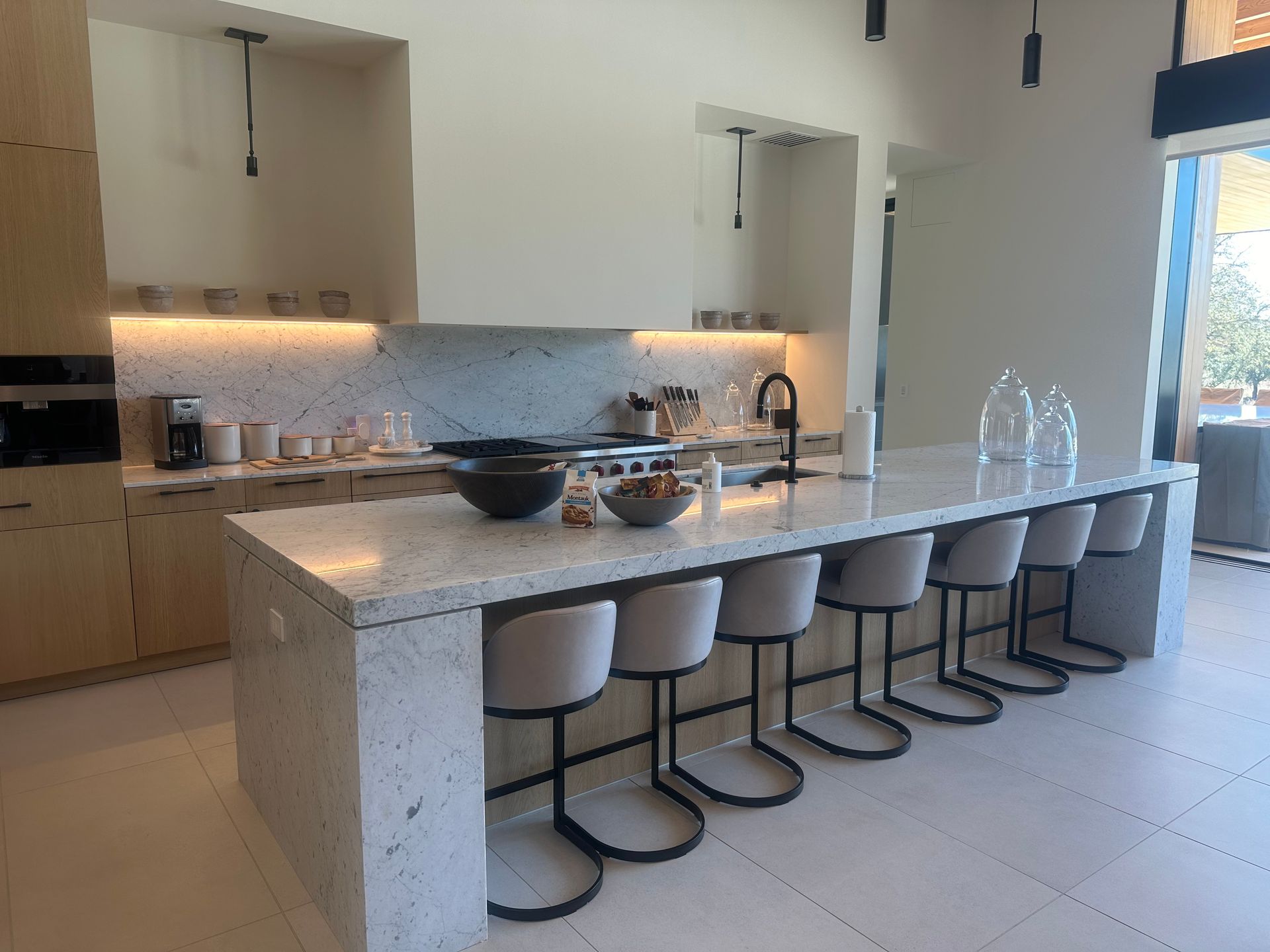 a kitchen with a large island and stools