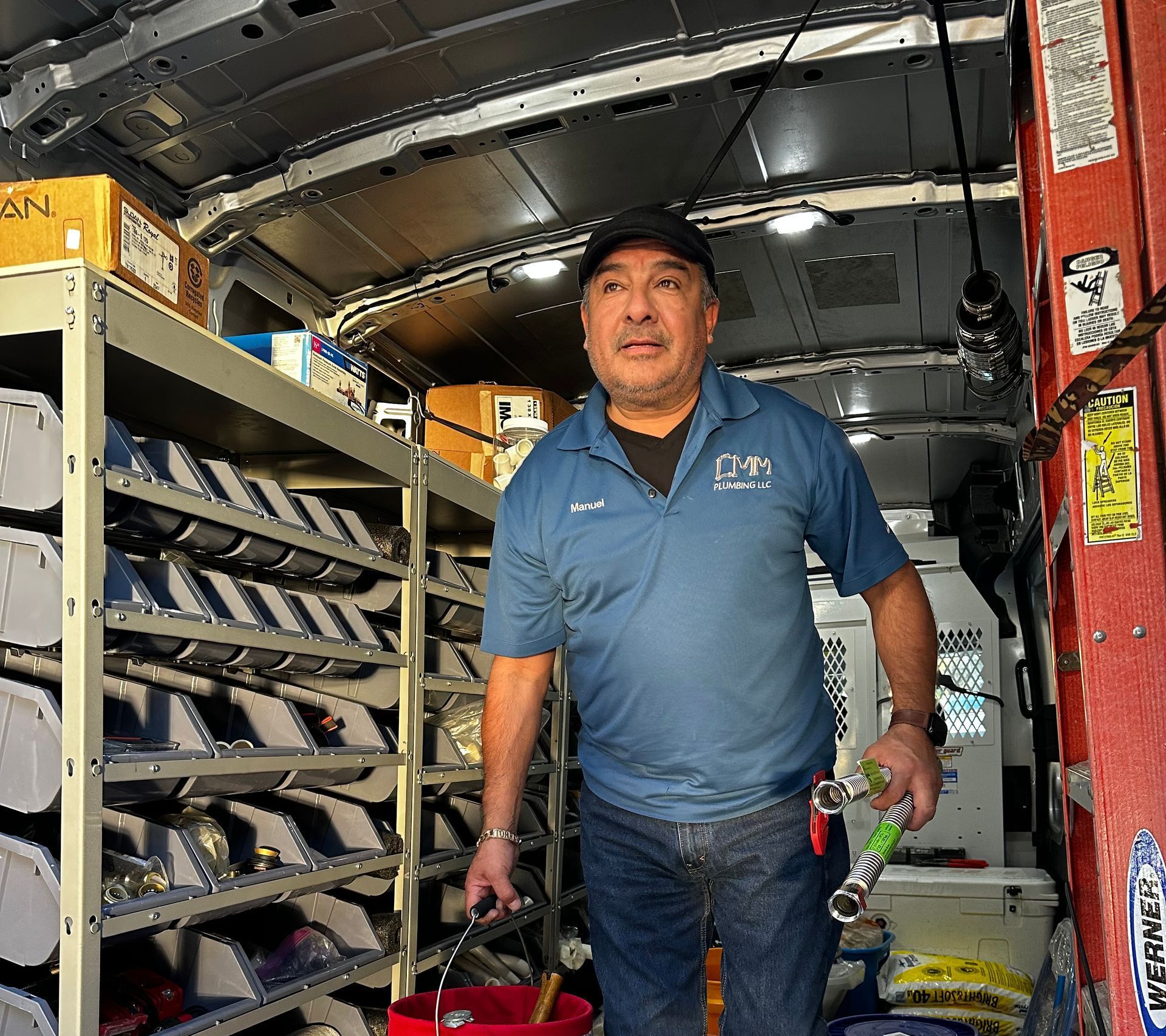 a man is working on the ceiling of a building .