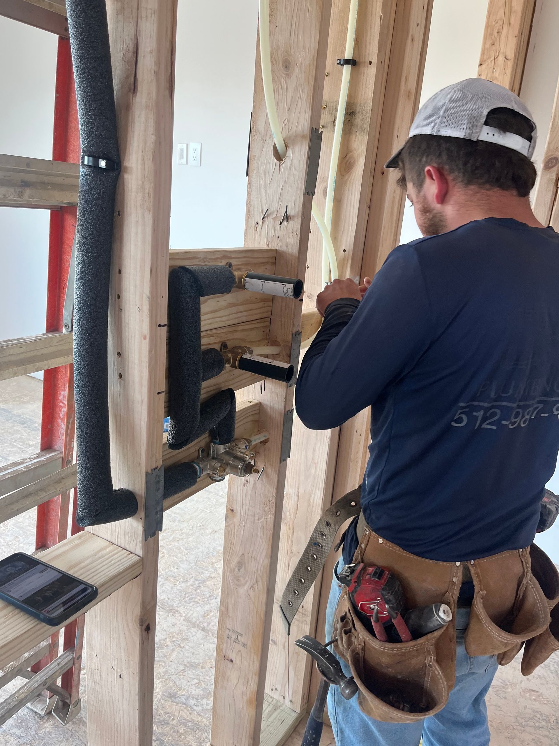 a man is working on a wooden wall .