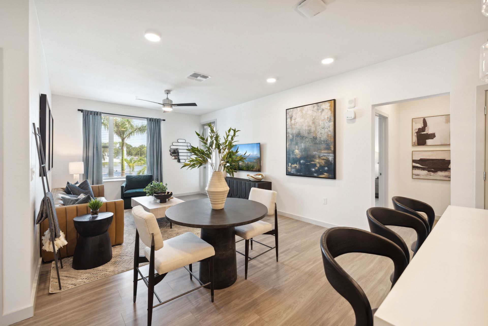 A living room with a table and chairs in it