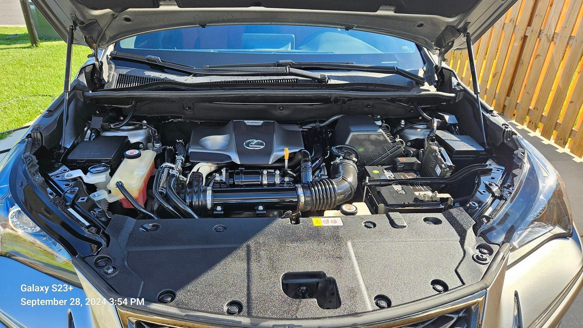 The engine of a car is shown with the hood open.