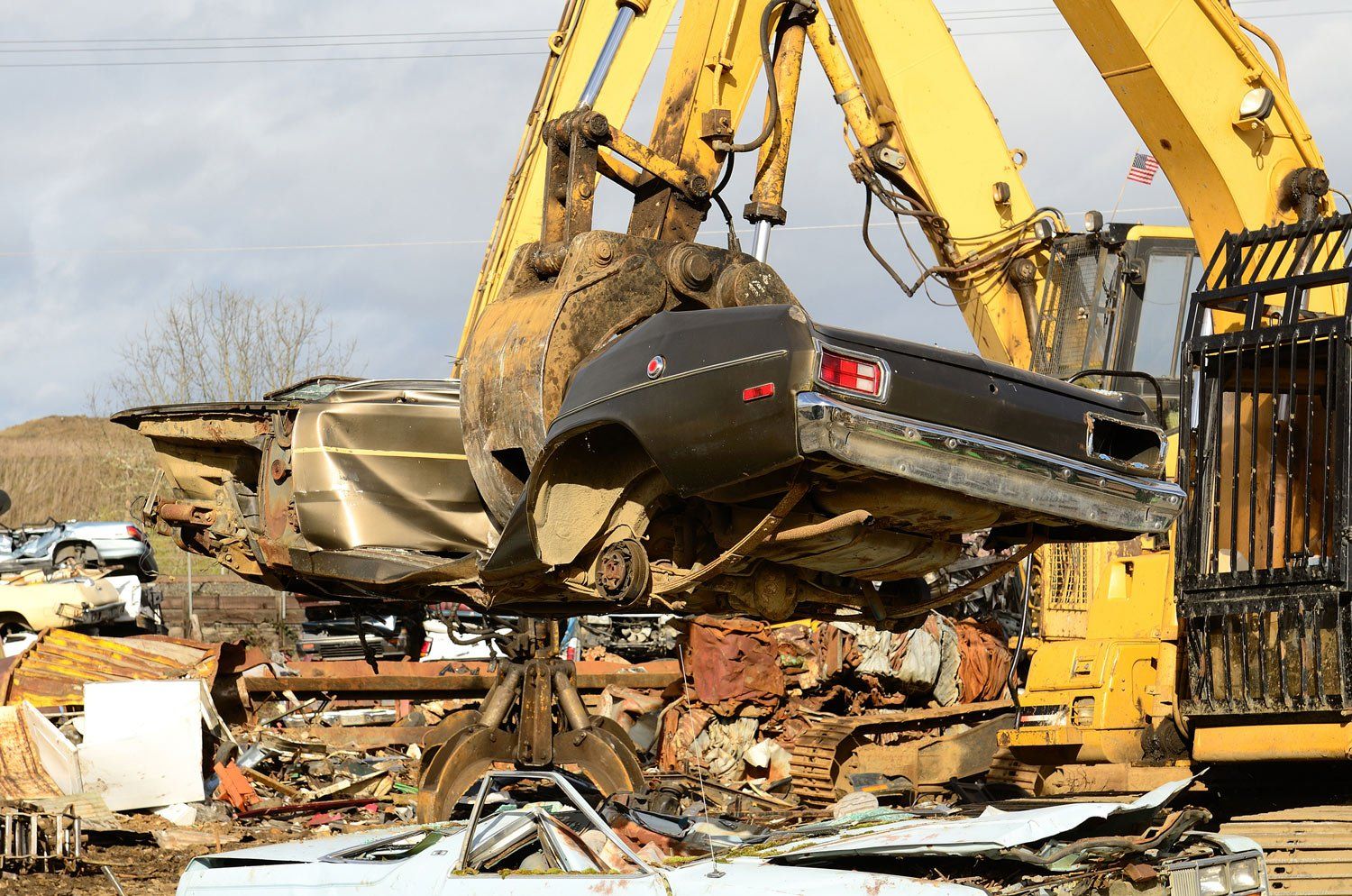 Car Being Lifted by a Heavy Equipment — Vernal, UT — Basin Recycling
