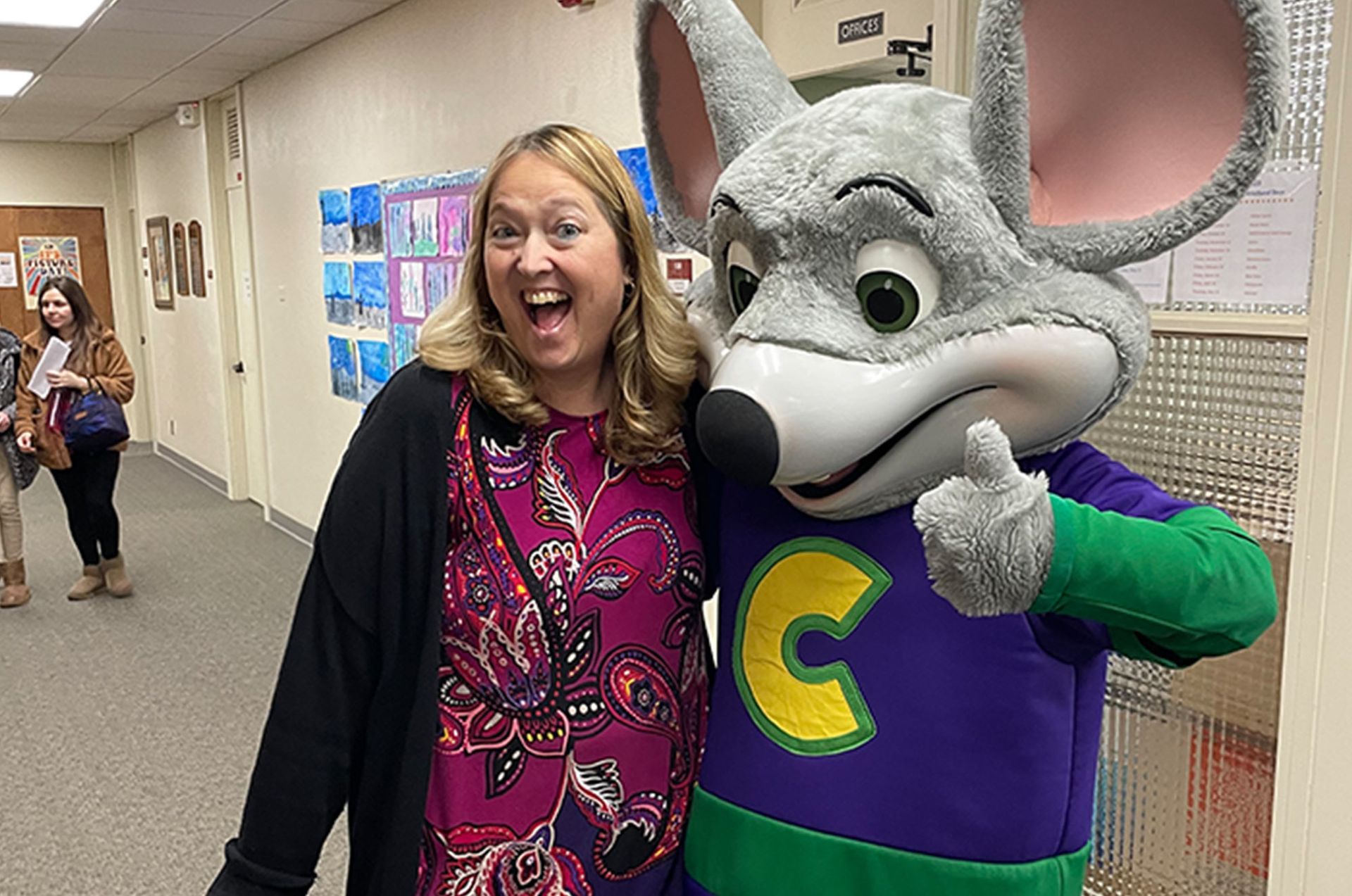 Woman poses with Chuck E. Cheese mascot, both smiling. Careers | Immanuel Lutheran School | Belvidere, IL