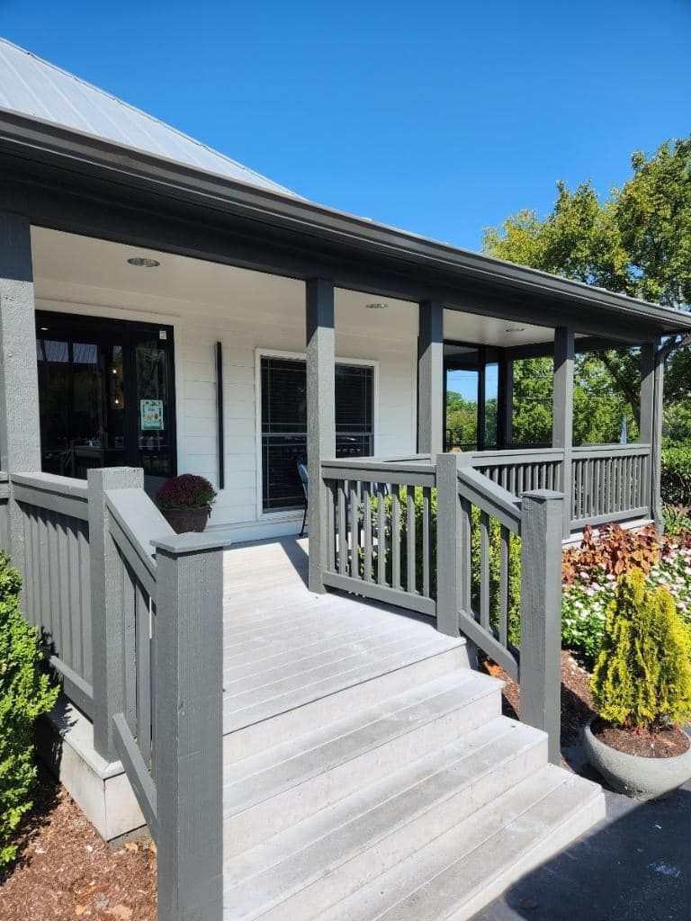 A house with a porch and stairs leading to it