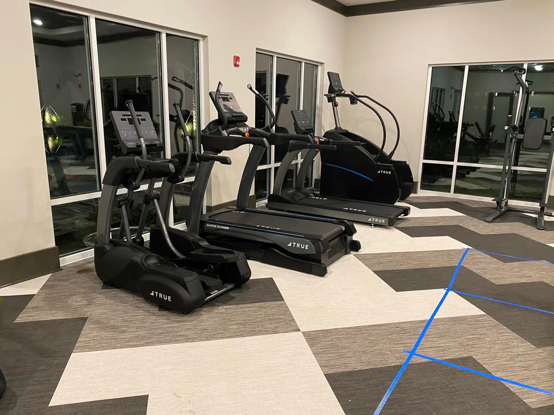 A gym with treadmills , ellipticals , and other exercise equipment.