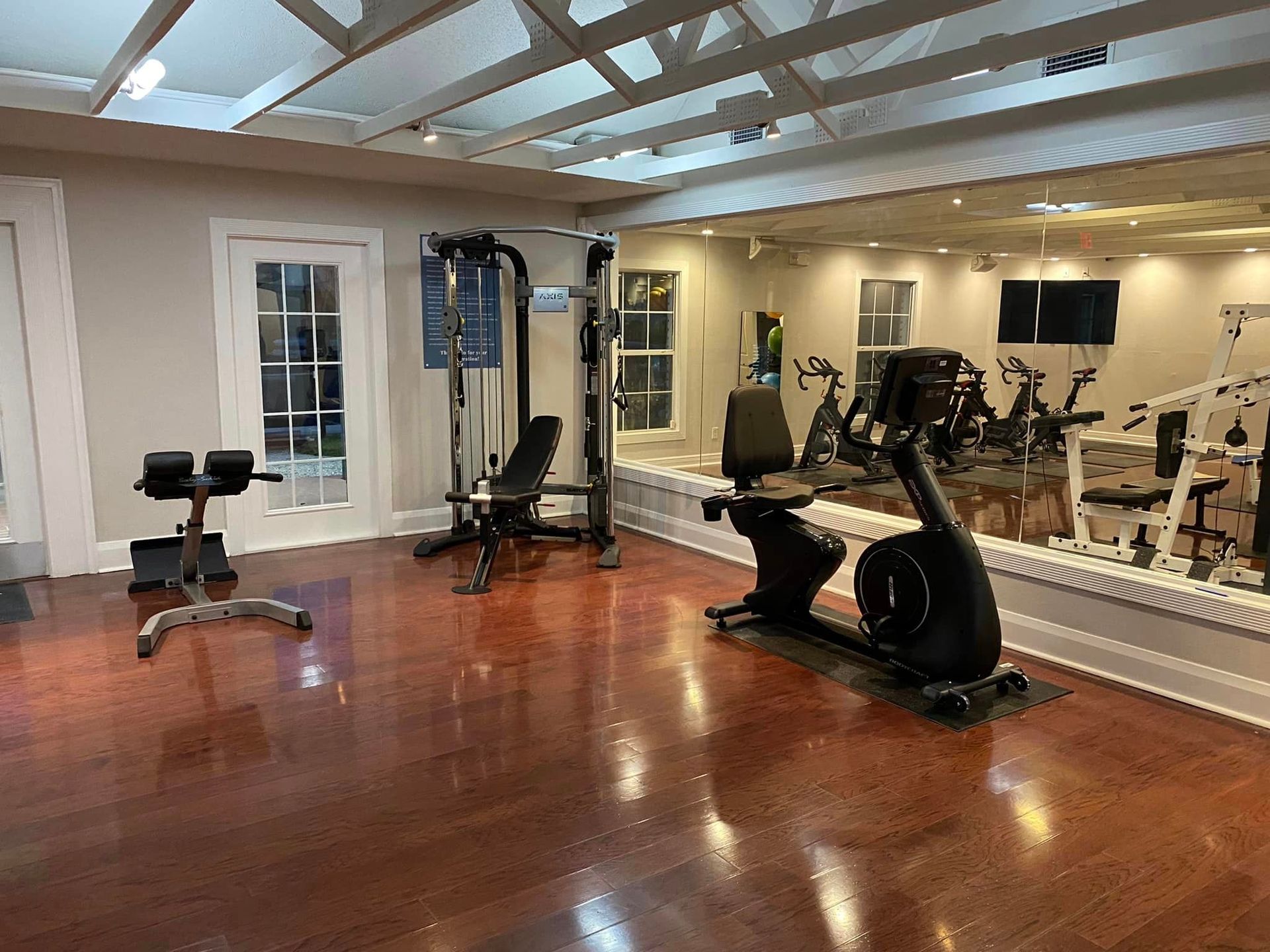 A large room with a lot of exercise equipment in it.