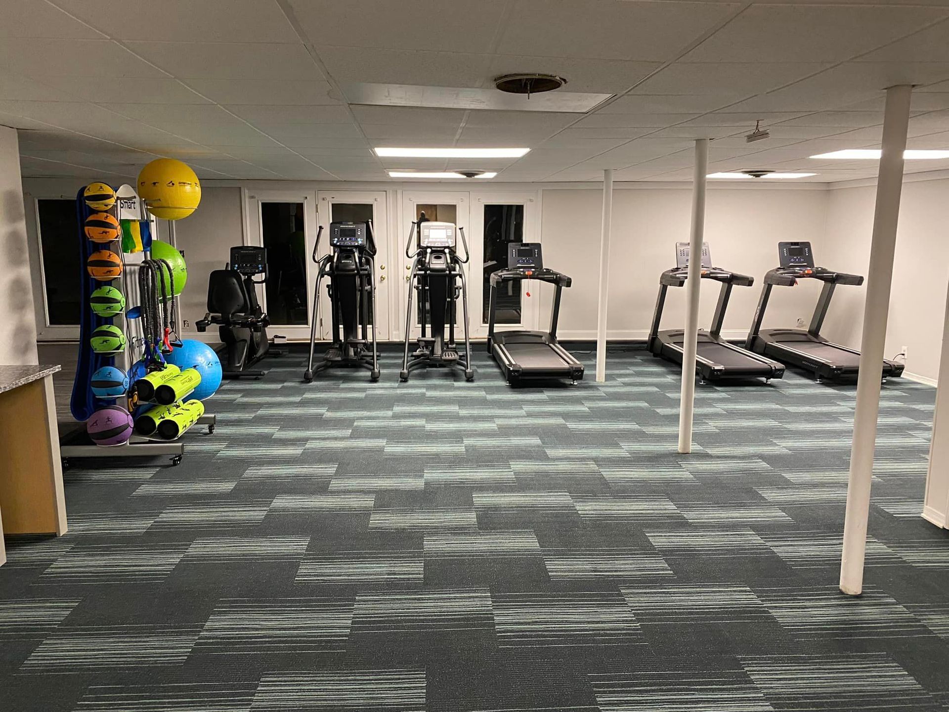 A gym with treadmills , ellipticals , and other exercise equipment.