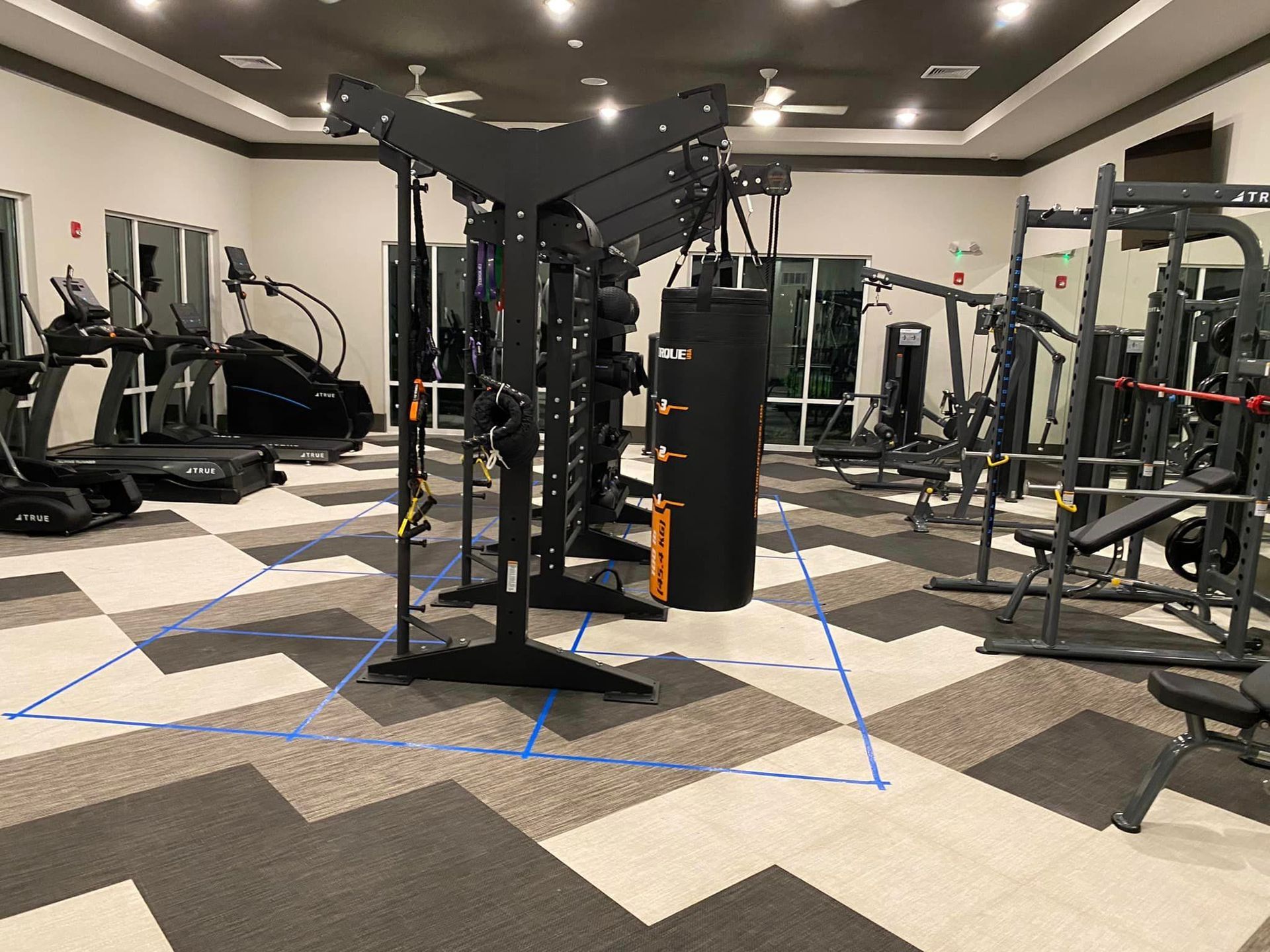 A large gym filled with lots of exercise equipment.