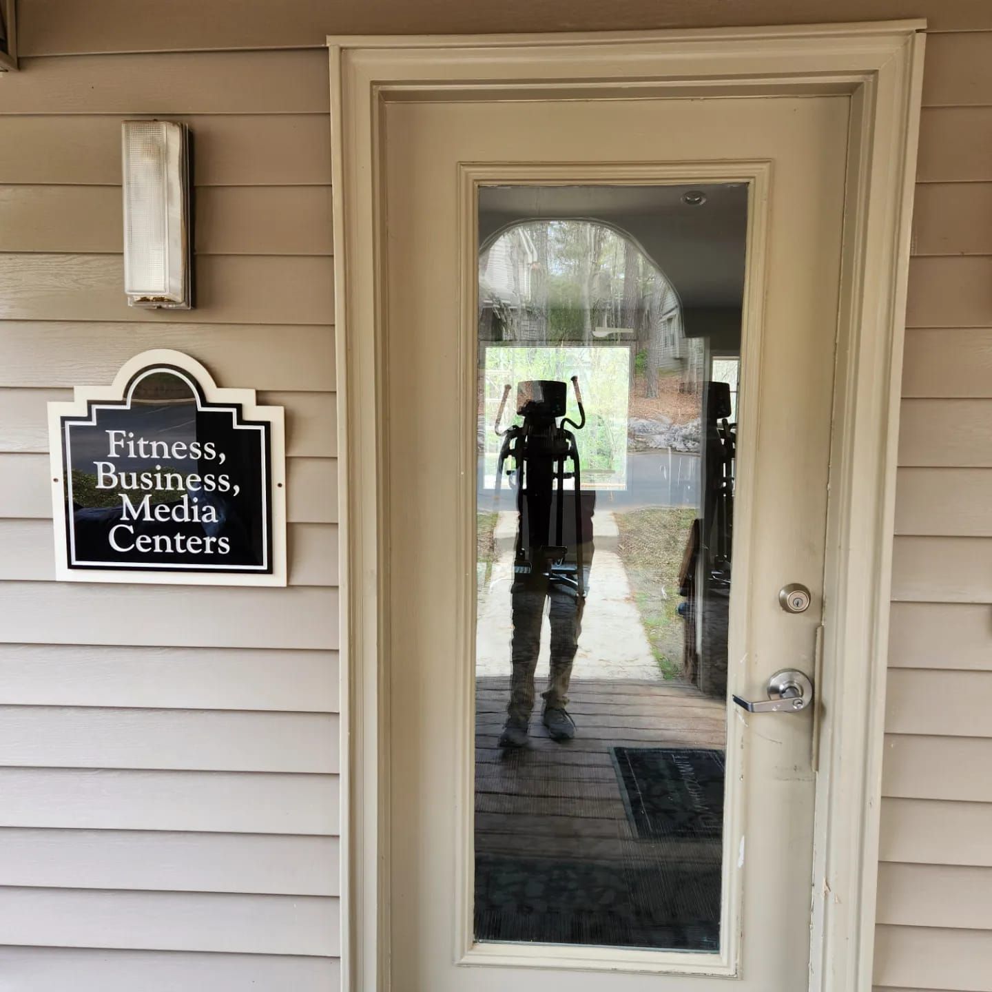 A door with a sign that says fitness business media centers