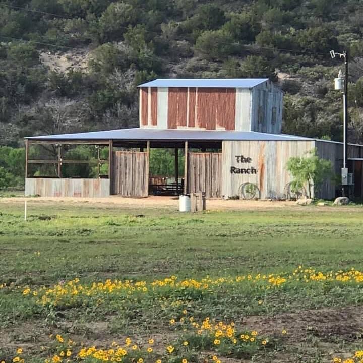 A barn with the word ranch on the side of it