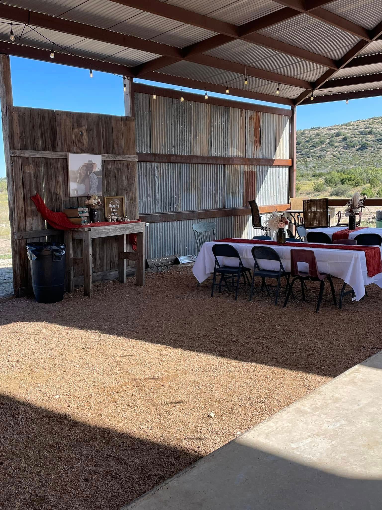 A barn with tables and chairs set up for a wedding reception.