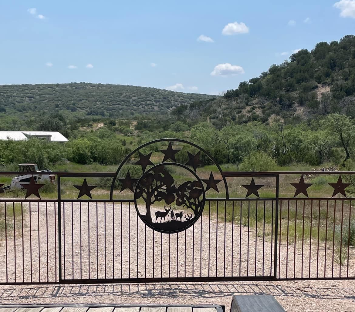 A fence with a picture of a tree and stars on it