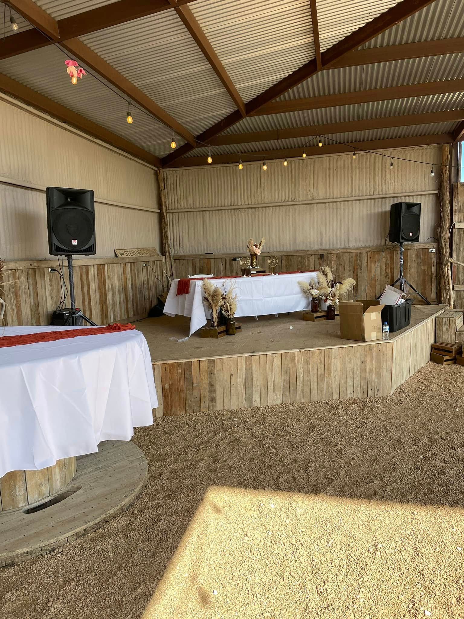 A large room with tables and speakers in it.