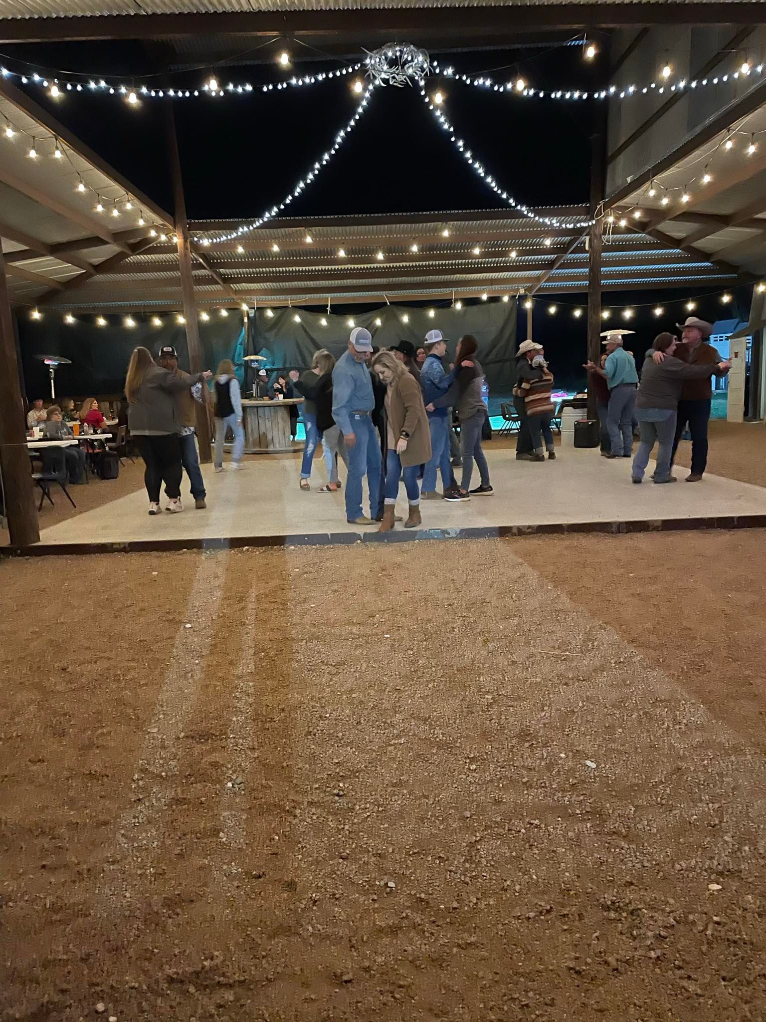 A group of people are dancing on a dance floor at a party.