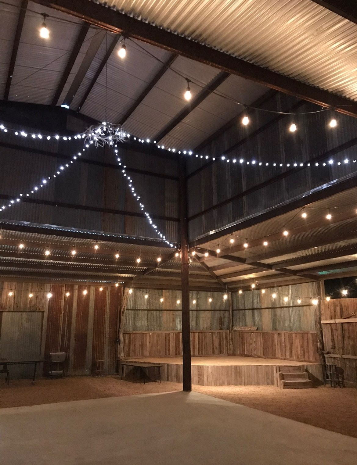 A large room with lots of lights hanging from the ceiling