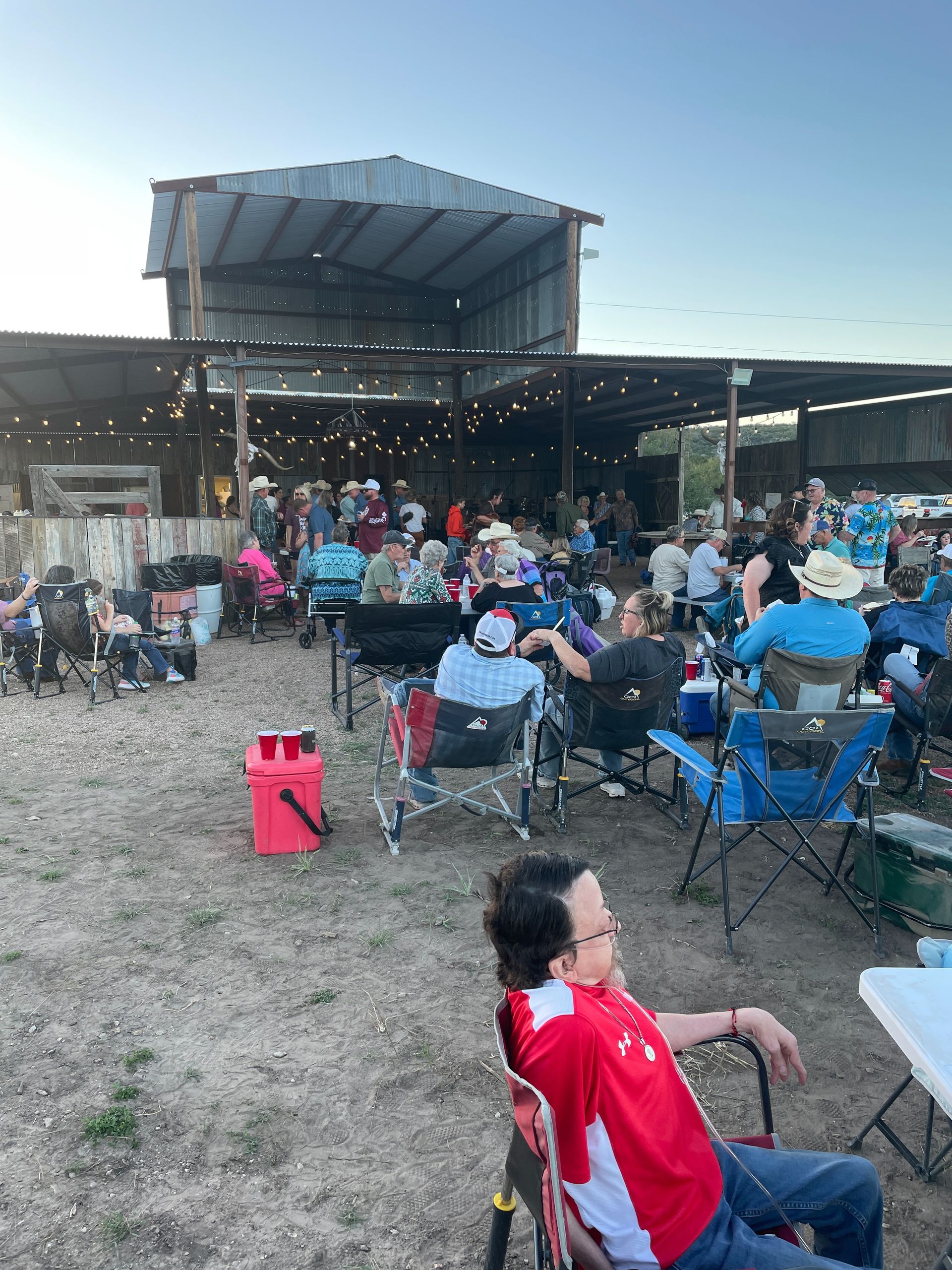 A group of people are sitting in chairs in front of a stage.