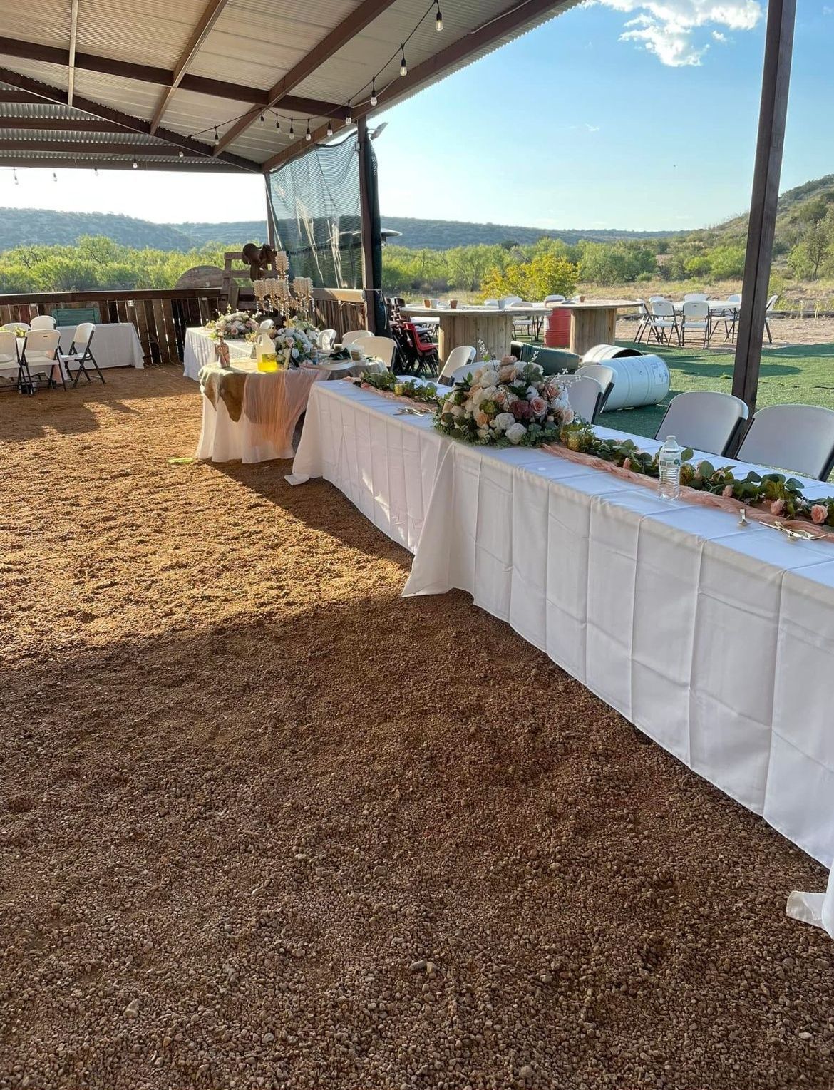 There are tables and chairs set up for a wedding reception.