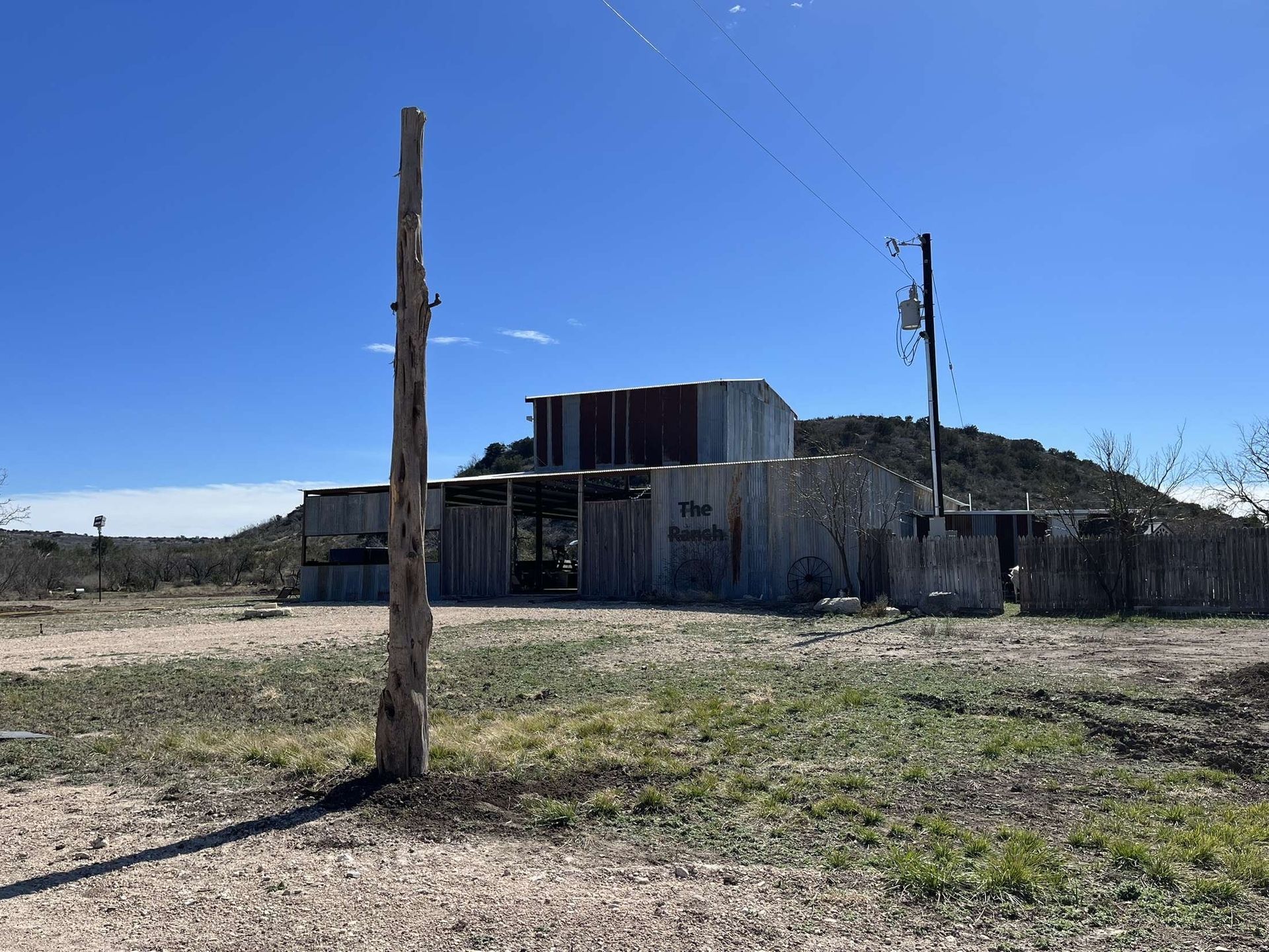 An old building with a telephone pole in front of it.