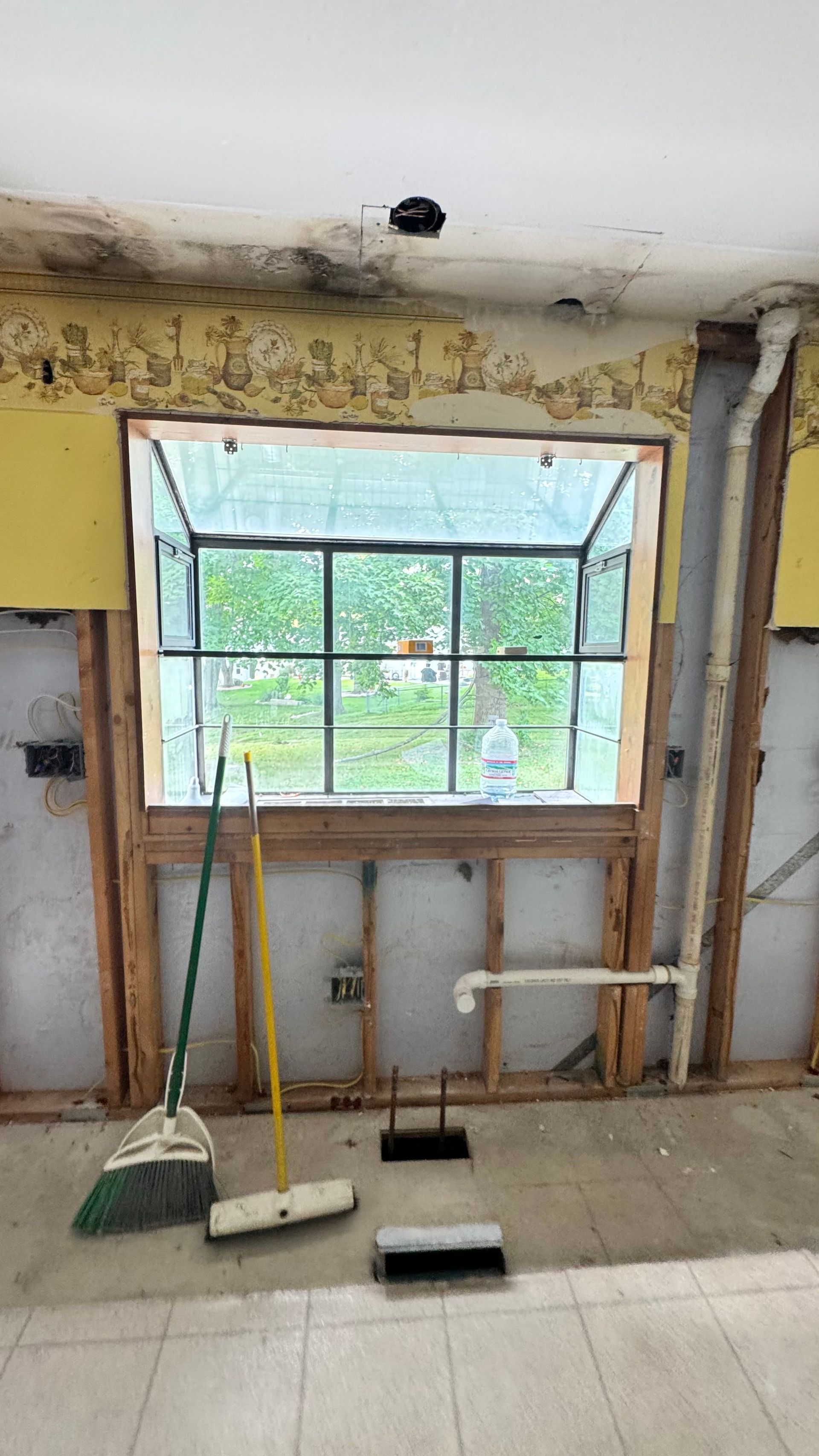 A backyard with a large swimming pool and a fire pit.