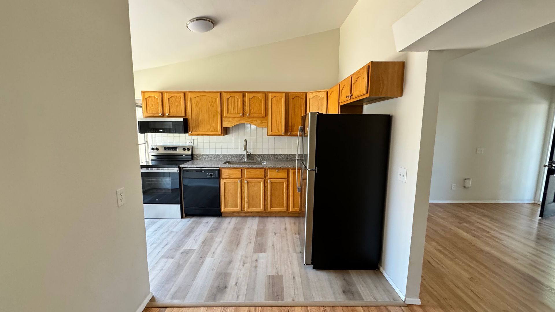 A backyard with a large swimming pool and a fire pit.