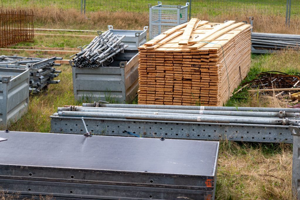 A pile of wood is sitting in the middle of a field