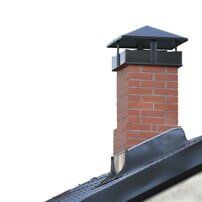 Man cleans fireplace with spatula - Chimney Cleaning & Repair service in Cumberland, RI
